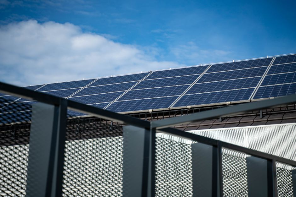 Sun shining brightly over a home solar roof